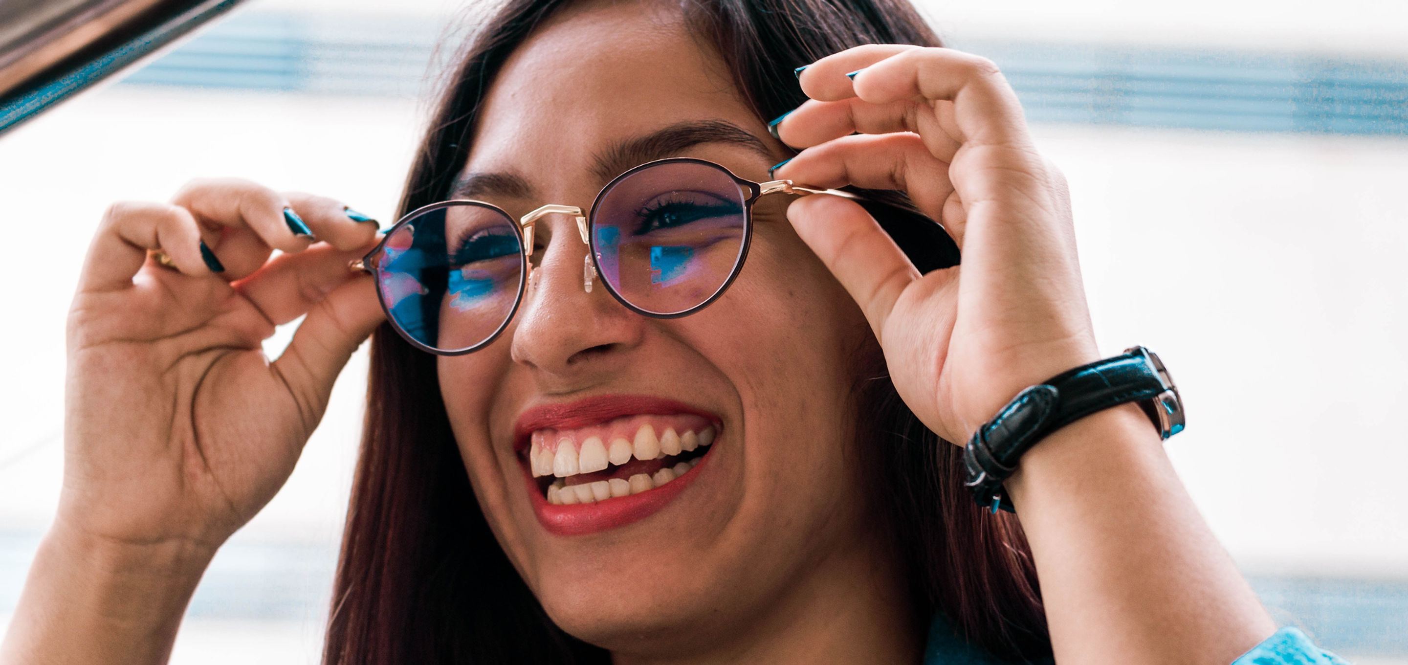 Smiling woman trying on new glasses