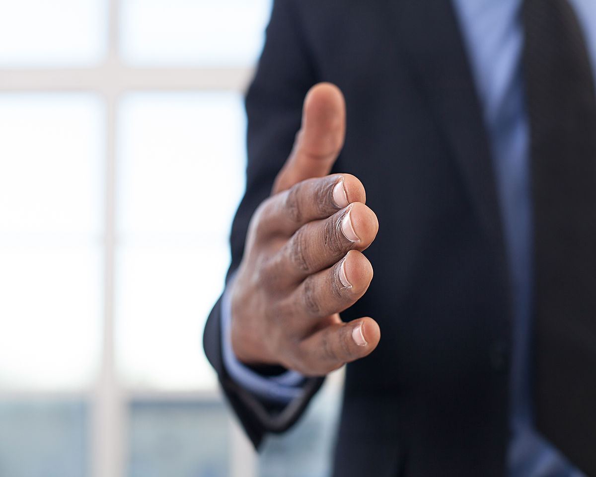 Doctor reaching out for a handshake