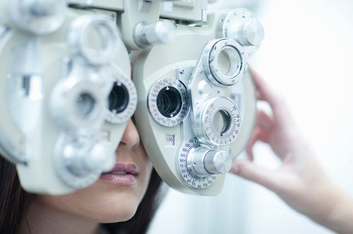 Patient looking through a phoropter